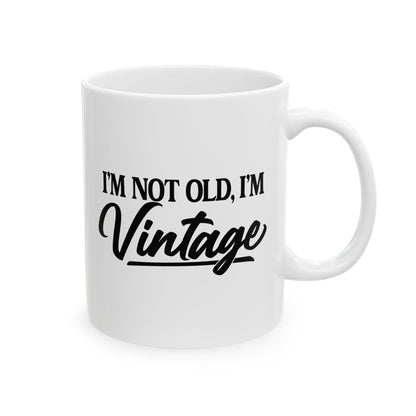 White mug with 'I'm not old, I'm vintage' text on a white background