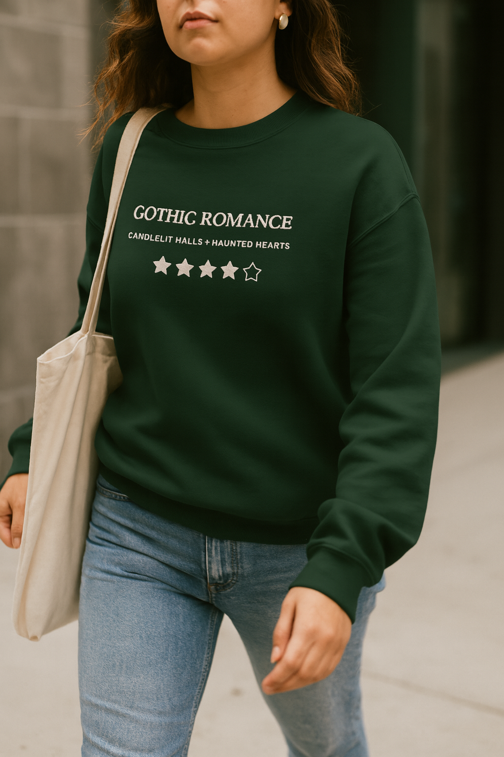 Person wearing a green sweatshirt with 'Gothic Romance' text, standing outdoors.