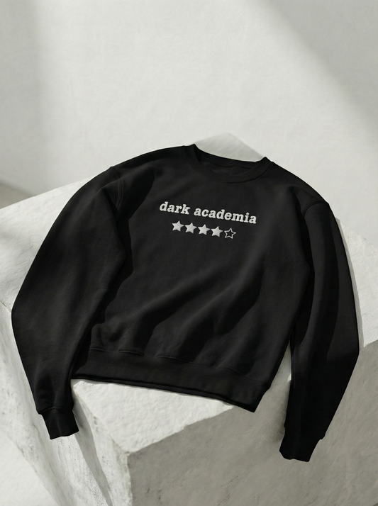 Black sweatshirt with 'dark academia'  embroidered text on a light gray background